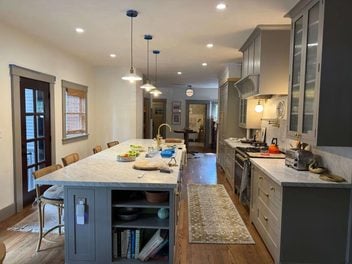 Remodeled kitchen with large island, pendant lighting, and custom cabinetry