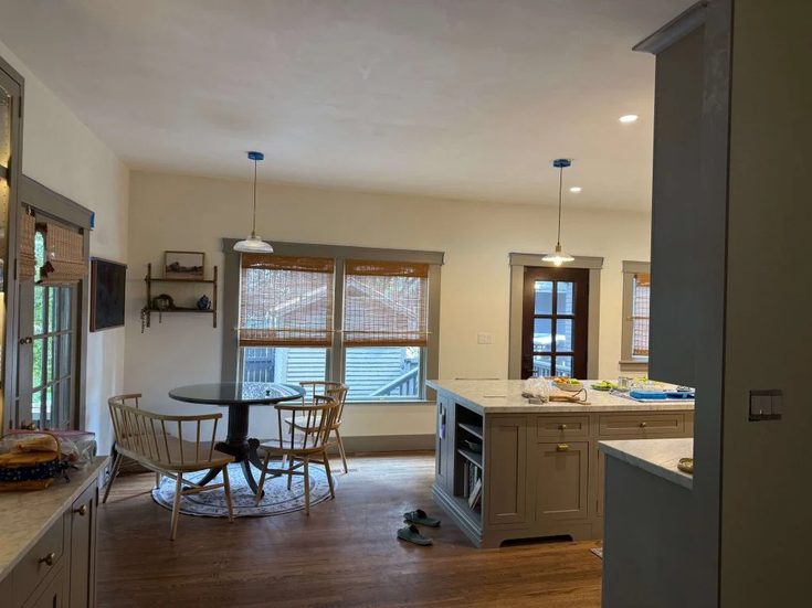 Remodeled kitchen island and dining area with custom cabinetry and natural light