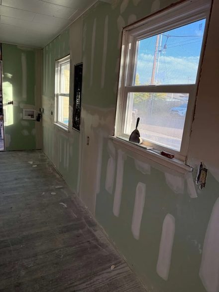 Room with moisture-resistant drywall taped at the seams and a large picture window